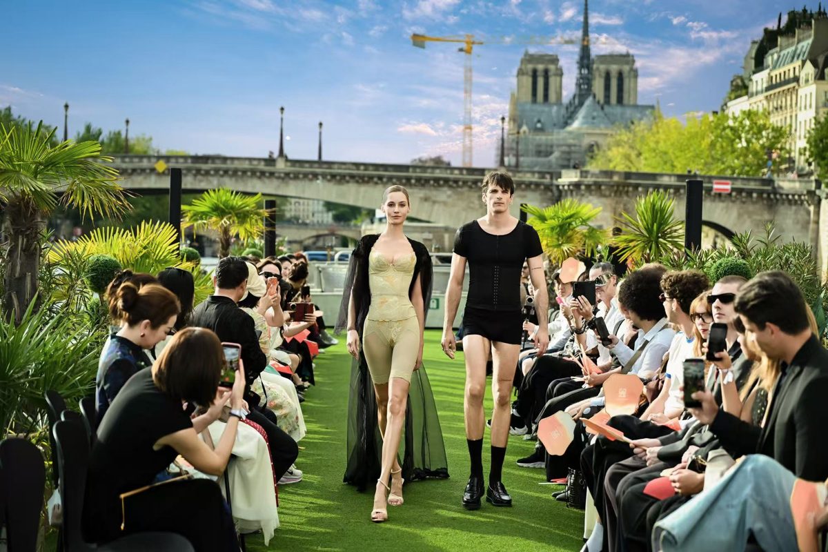 Models walking in YuMei East shapewear on the deck of a boat in front of Notre-Dame de Paris and the audience